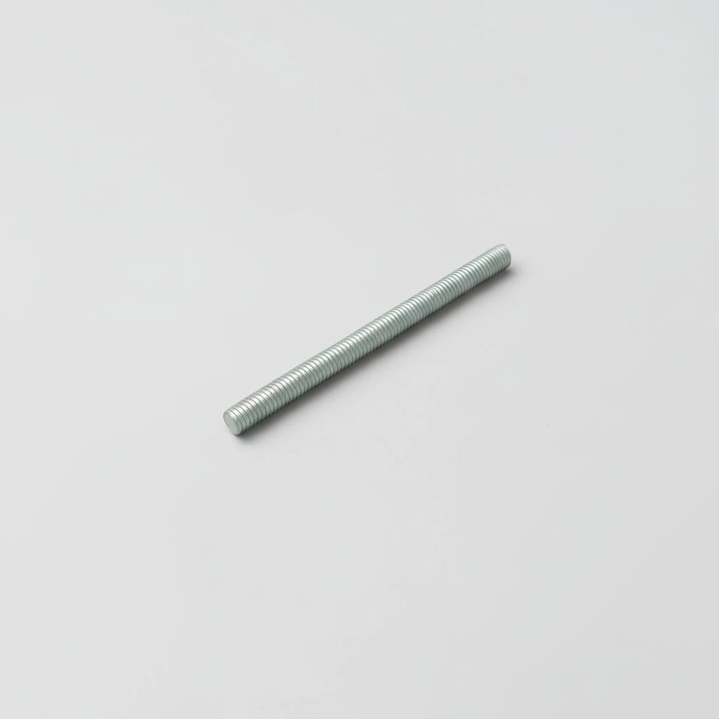 Long, thin metallic rod on a light gray background